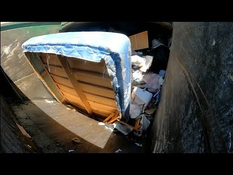 Waste Management garbage truck packing garbage