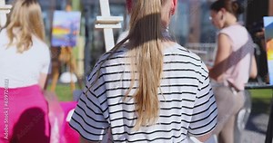 Process of drawing, group class of talented students with painting easels and canvases during lesson of watercolour painting outdoors, drawing class for adult artists in art school