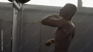 Boxer punching speed ball, training reaction with boxing punchbag, side view zoom in shot. Young fighter exercising with professional equipment in gym