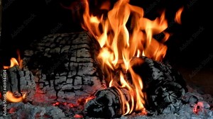 Wood burning in a refractory brick oven. Burning braids in the background.