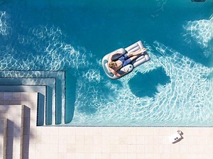 Don't Mind Us, We'll Just Be Floating in This Motorized Pool Lounger All Summer Long