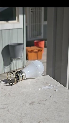 Slow motion light bulb bursting from a pellet rifle.