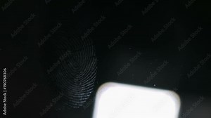 The forensic scientist examines the evidence. Fingerprints close-up. The detective uses a bright light source. Stock Video