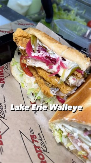 Premium Fish Sandwich at @detroit75kitchen is The Lake Erie Walleye. Made with lettuce, tomato, pickles, sweet pickled onions, and house-made Old Bay tartar sauce. We’re open til’ 8pm every Friday in Southwest Detroit and Troy! | Detroit 75 Kitchen