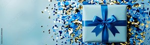 Luxury blue gift box with blue ribbon and confetti, Closeup flat lay Gift Box on blue background, Valentine's Day, Holidays gifts concept, anniversary, birthday. Copy space template web site banner