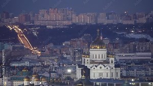 The famous symbol of Moscow, the Cathedral of Christ the Saviour, at night against the background of the cityscape. The famous establishing plan of the Cathedral of Christ the Saviour