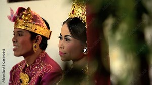 Wedding Balinese style bride and groom attending the marriage ceremony in traditional dress Indonesia South East Asia