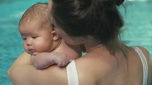 Mother with her little baby in a swimming pool - Free Stock Video