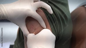 A healthcare professional administering a vaccine to a patient's upper arm, highlighting the importance of immunization, Intramuscular the vaccine is injection in the muscle.