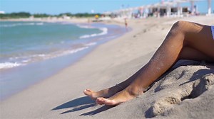 Woman legs closeup at beach during summer vacation