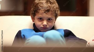 Young boy watching screen. Kid hypnotized by screen watching content. Child in hypnosis state