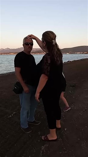 Beachside Affection: A Romantic Moment Captured