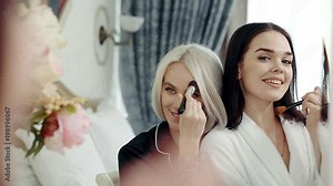two young women lesbians, doing makeup and laugh