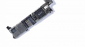 Kiev, Ukraine - March 11, 2021: hand puts an iphone se apple electronic board with A9 processor and an iphone 4 electronic board with a4 processor on a white background close-up