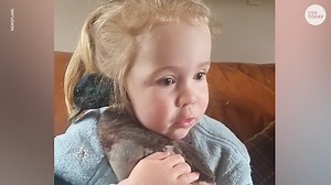 Little girl sings while cuddling her pet duck