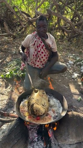 Hadzabe tribe bushmen Dudukwe prepare very special meal today in the bush