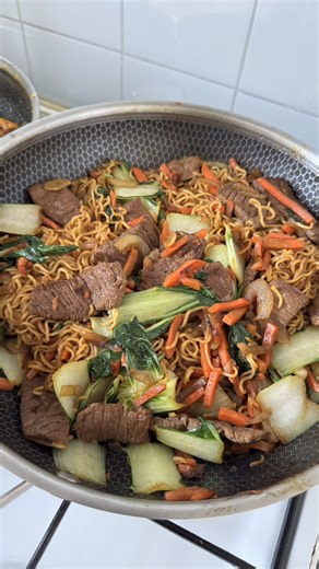 Mie Goreng with Beef For 3–4 servings Ingredients: • 250 g yellow noodles • 250 g beef steak • 250 g carrots • 1 bok choy • 1 tsp corainder powder • 4 cloves garlic, chopped • 1 tbsp sesame oil • 2 tbsp oyster sauce • 2 tbsp soy sauce • 1 tbsp sweet soy sauce • ½ tbsp brown sugar • 1 tsp white pepper • Olive oil (or cooking oil) • Fried onions (for garnish) Instructions: 1. Bring a large pot of water to a boil. Cook the noodles according to the package instructions, then drain and set aside. 2. 