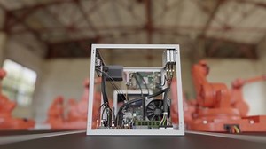 Industry 4.0 concept. Automated robotic arms in factory assembling computer.