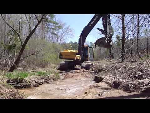 Excavator Digging Creek Sand