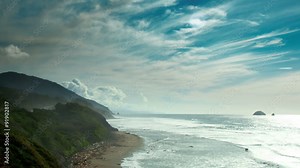Time Lapse 2045: Time lapse waves crash into the Pacific Coast shoreline under a deep blue sky.