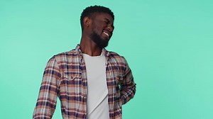 African american man touching injured sore back, backache, suffering lower lumbar discomfort spasm