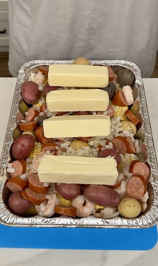 Easy Seafood Potluck Dinner Danny makes a seafood dinner using 8 cobs of corn, shrimp, mini potatoes, sausage, onion, and butter. Bake for an hour on 350F serve and enjoy! | Danny N’s Kitchen