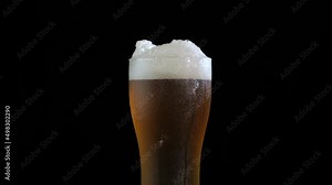 Pouring beer into a rotating glass.