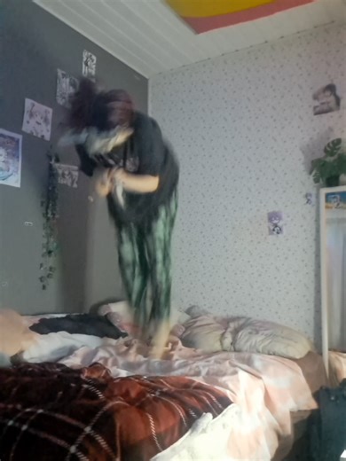 Cat Jumps on a Bed in a Playful Moment