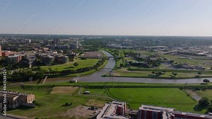 Fort Worth, Texas and Trinity river surrounded by city parks and modern residential buildings from an aerial point of view in a bright day