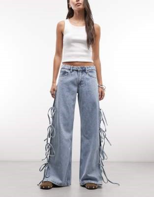Monki low waist wide leg jeans with side tie bow detail in blue wash | ASOS