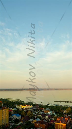 Vertical video. Ulyanovsk, Russia. Volga River near Ulyanovsk. Evening light. Clouds. Timelapse, ...