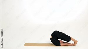 Man demonstrates plow pose and crab pose/table top pose on a yoga mat against a white background.