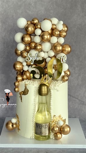 Rochelle Makyn on Instagram: "Elegant. Timeless. Luxurious. This custom 50th birthday cake was designed to make a statement—featuring a modern white base, cascading gold and pearl accents, and a bold personalized topper. Every detail was carefully crafted to celebrate a milestone in true style. Perfect for birthdays, anniversaries, and luxury celebrations. Suga Mama Cakes JM Portmore, St. Catherine Custom Cakes • Celebrations • Milestones Call/WhatsApp: 876-295-5005 #SugaMamaCakesJM #PortmoreBak