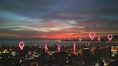 Aerial view of a modern city and lots of location pins. Location...