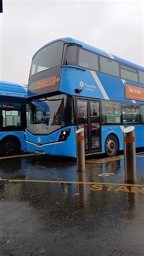 Two translink bus reversed out and one arriving into the bus station.
