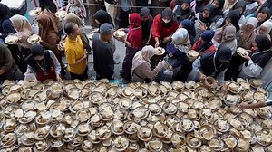 Yogyakarta, Indonesia - 6 March 2025 : A number of people gathered to queue during the distribution of takjil at the Jogokariyan Mosque which was held during the month of Ramadan before Eid al-Fitr