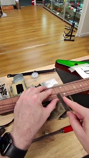 After I’ve clean out the fret slots, I like to add a slight bevel on the slots before installing the new frets. I usually do this with a V-cut nut file but you can certainly use other files as you please. Fret wire doesn’t necessarily have 90 degree right angles all the way up from the tang to the bottom of the fret due to the extrusion process used to make the fret wire. This helps them sit nicely in place. #fretwork #refret #refretting #guitarrepairs #guitarrepairshop | Port Mac Guitars