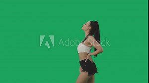 Side view of brunette waving black and white checkered racing flag to signal start of competition. Young woman posing against background of green screen close up. Slow motion ready, 4K at 59.94fps. Stock Video
