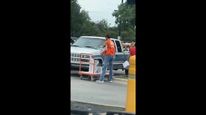 Home Depot worker puts his all in to lift single box whilst colleague casually carries multiple