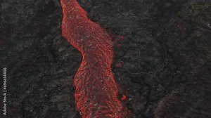 Aerial drone view over river of molten hot lava erupting from the Litlihrutur Iceland volcano and flows through dark rock in 2023. Tourist attraction to beautiful and dangerous disaster.