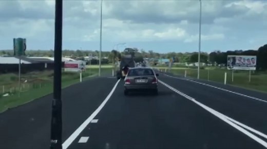 Shocking footage shows woman hanging out the window of moving car