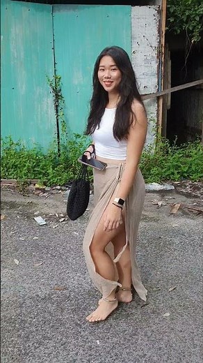 Real barefoot Asian girl walking on hot asphalt road in ankle cuffs (Preview #1)