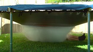 Here's a man getting showered by a giant water balloon in slow motion