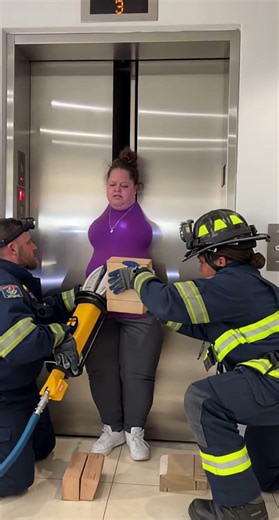 A woman is wedged tightly between partially closed elevator doors #obese #women #stuck #rescue