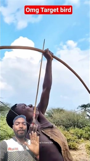 The hunter on the tribal tribe is aiming at the flying bird. 🐦