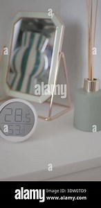 A clock displays the temperature and humidity in a room with decor Stock Video Footage - Alamy