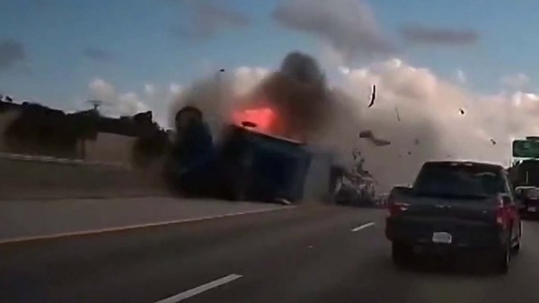 Tractor trailer erupts in flames after rolling over on Florida highway