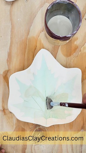 I want the finished piece to be glossy so it's time to cover it with clear glaze. I have to be careful not to disturb the underglaze, so I avoid brushing back and forth. I make sure that the glaze gets to into all parts of the texture. I will add two layers of the clear glaze to get my desired effect. Clear glaze won't be clear until it's fired ;-) #clearglaze #glossyglaze #ceramics #pottery | Claudia's Clay Creations