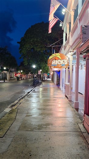 This is Duval Street before the party wakes up. Empty sidewalks. Neon lights still glowing from the night before. A rooster crowing somewhere in the distance. Sloppy Joe's sits quiet. Waiting. In a few hours, this street will be packed. Music pouring out of every bar. People dancing in flip-flops with drinks in hand. But right now? It's just you and the ghosts of last night's stories. There's something magical about seeing Key West like this. Before the chaos. Before the crowds. When the island 