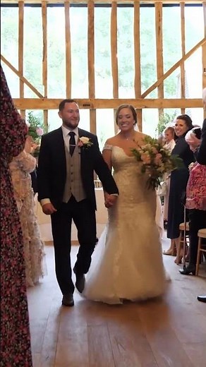 bride and groom walk up the aisle